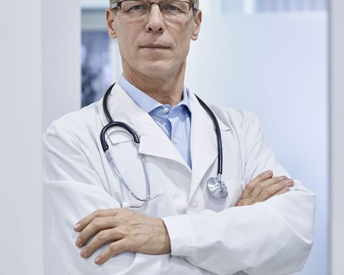 confident-old-medical-professional-doctor-standing-2021-09-02-08-41-38-utc.jpg